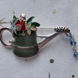 Adorable Brooch Featuring Watering Can with Green, Ivory and Red Flowers